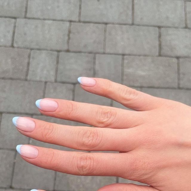 Elegant Soft Pink and Light Blue Nail Design: A Modern Twist on Classic French Manicure.