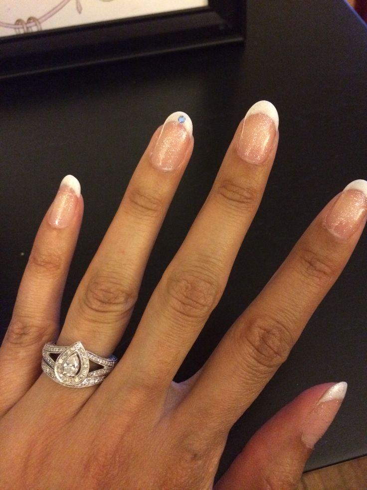 Elegant French Tip Nails with Sparkling Gem: A Refined Look for Special Occasions.