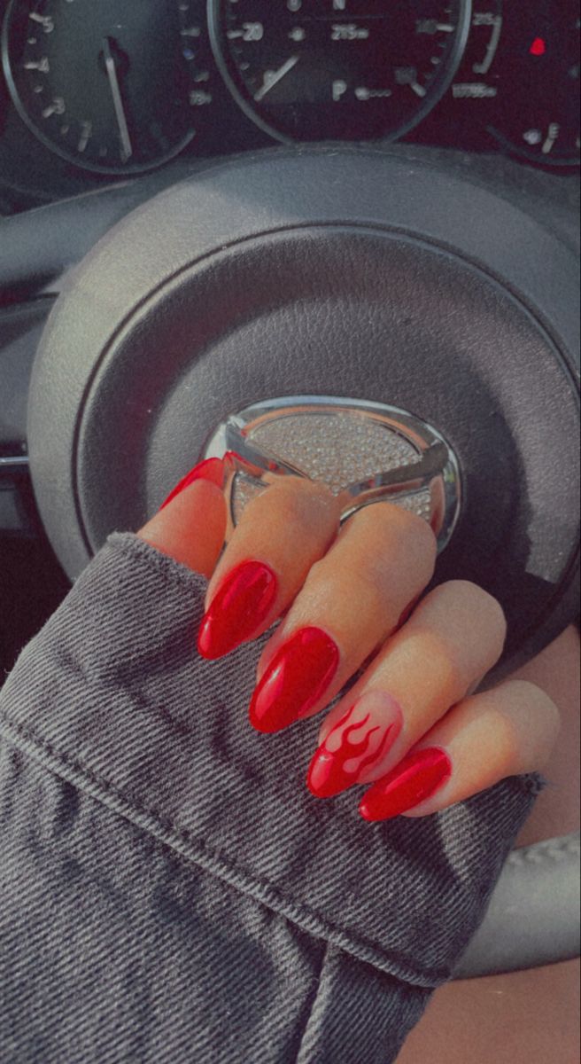 Bold Red Nail Design with Edgy Flame Pattern for Chic Style.