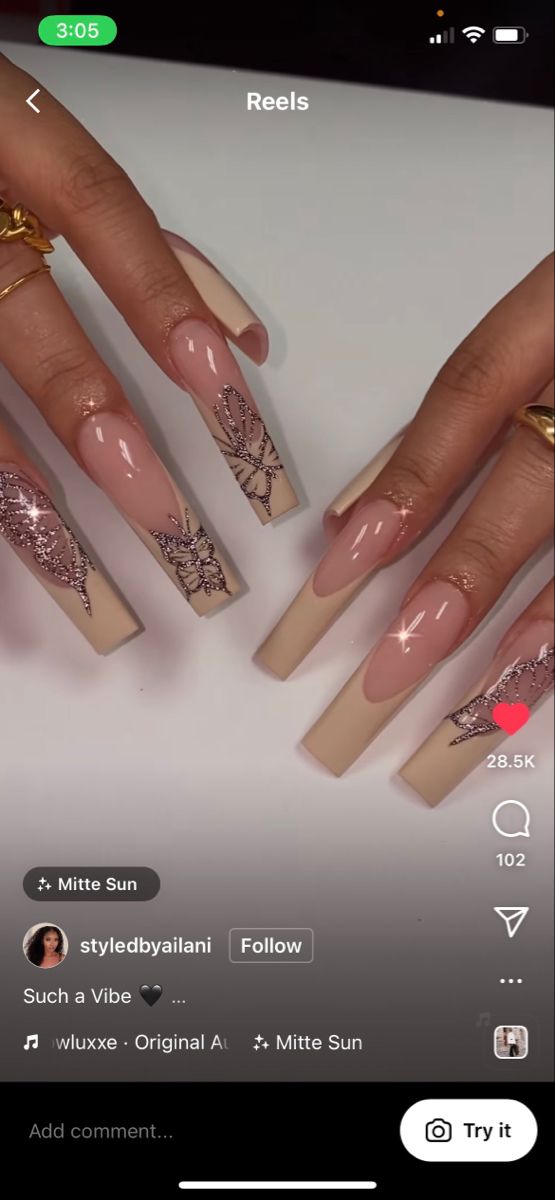 Elegant Nude and Soft Pink Nail Design with Floral Patterns and Elongated Shape.