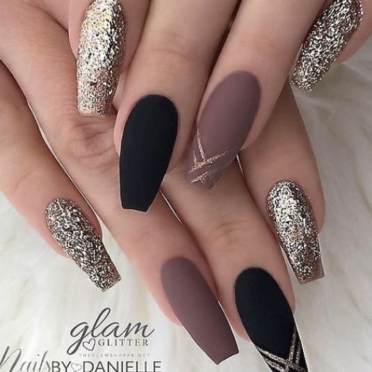 Chic Matte Black, Taupe, and Gold Accented Nail Design with Artistic Diagonal Lines.