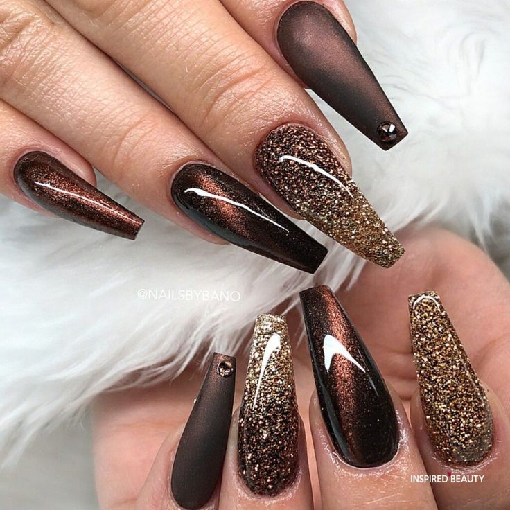 Sophisticated Nail Design with Ombre Gradient and Glitter Accents in Deep Brown and Metallic Shades.