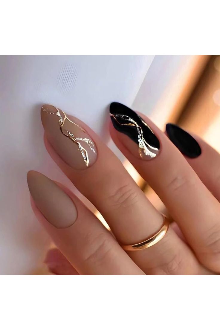 Sleek Nail Art: Matte and Glossy Beige & Black with Elegant Golden Accents.