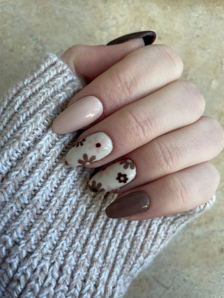 Elegant Neutral Nail Design with Floral Patterns and Mixed Finishes for a Refined, Playful Look.