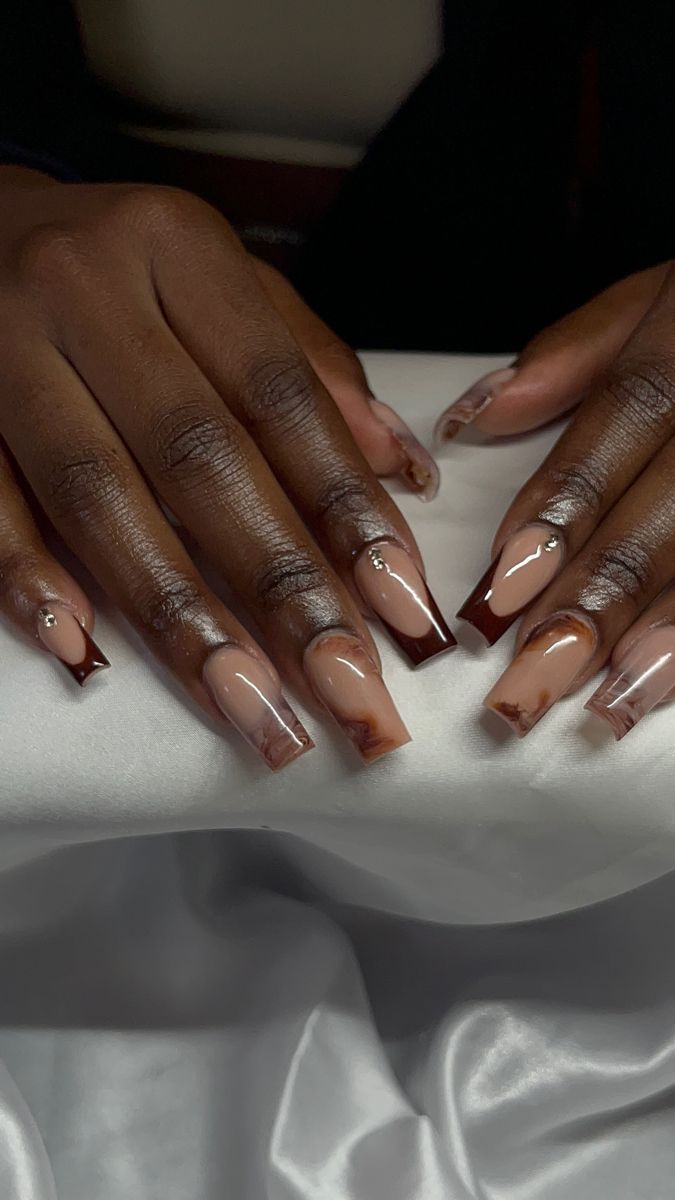 Elegant Nude and Chocolate Brown Nail Design with Marbled Tips and Rhinestone Accents