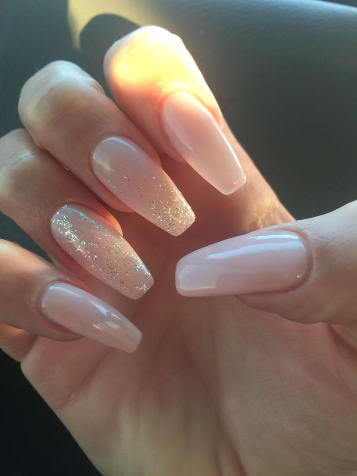 Sophisticated Soft Nude Nail Design with Glamorous Glitter Accents.