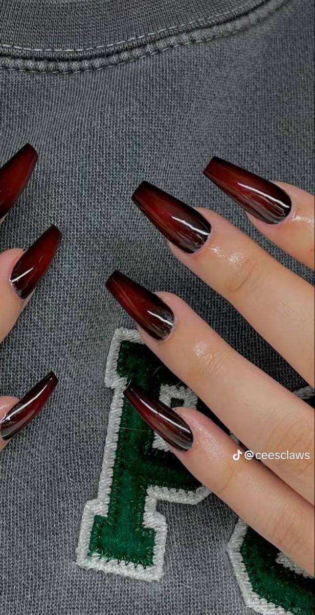 Elegant Glossy Burgundy and Black Nail Design with Angular Shapes for a Bold Look.