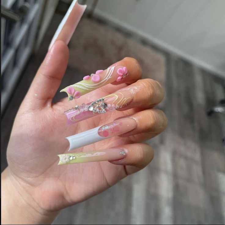 Whimsical Elegance: Intricate Pastel Nail Design with Floral Accents and Rhinestones