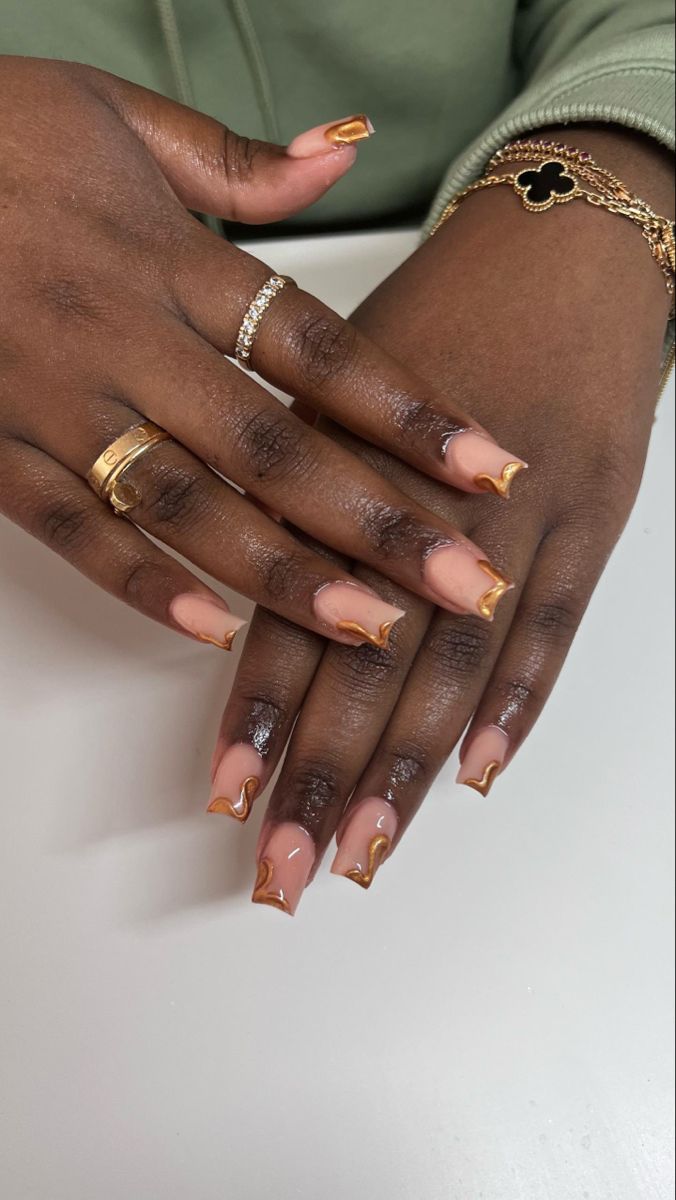 Chic Almond-Shaped Nails: Elegant Nude Base with Golden Tips for a Modern Twist.