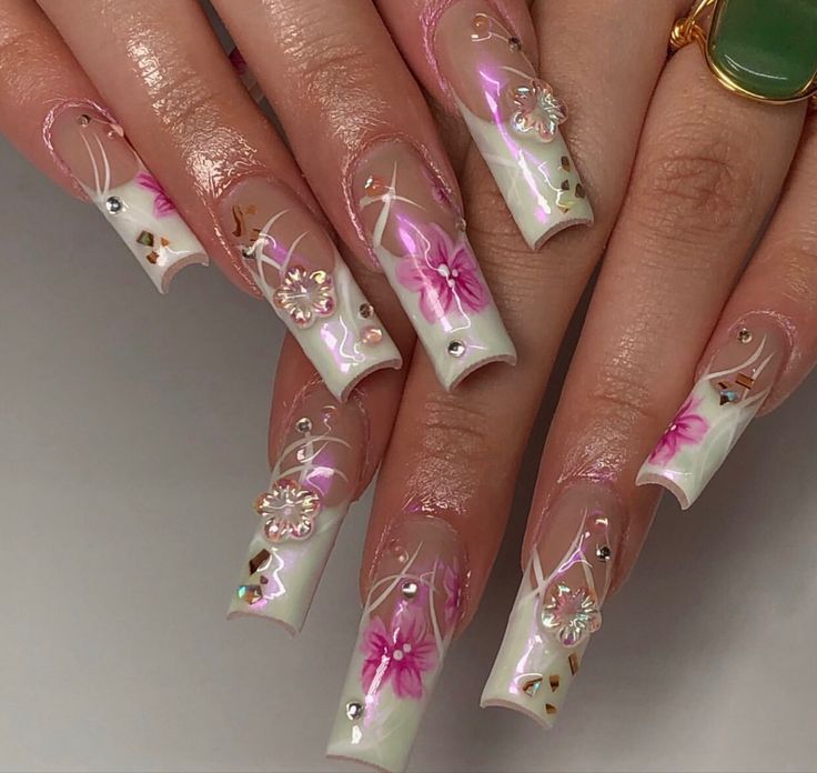 Sophisticated Nail Design: Soft White and Light Pink with Floral Accents and Sparkling Rhinestones.