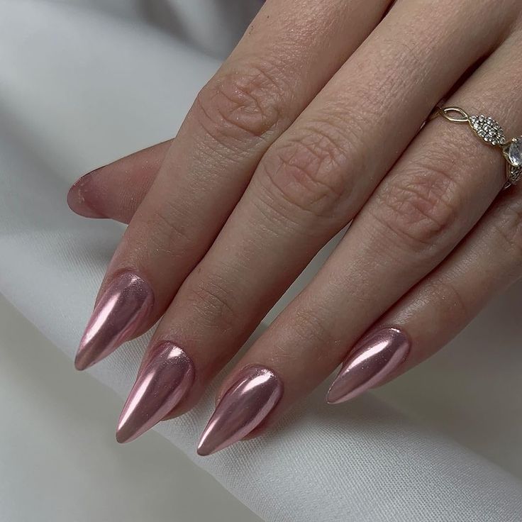 Glamorous Stiletto Nails in Glossy Rose Gold: A Sophisticated Touch for Any Occasion.