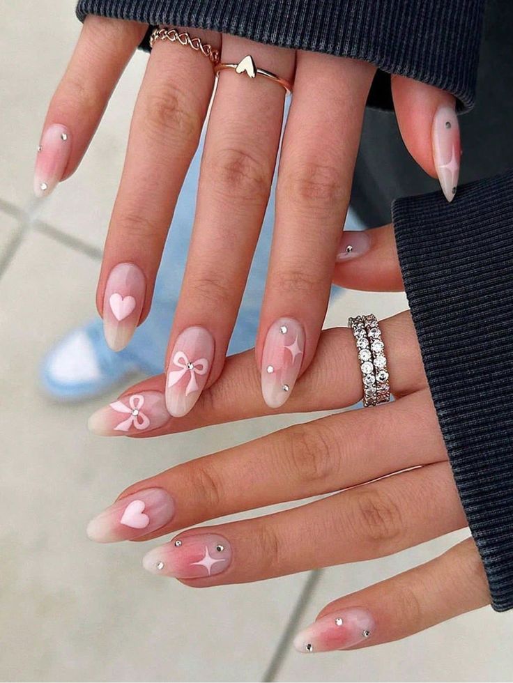 Playful Yet Sophisticated Nail Design: Soft Pink and Nude Gradient with Charming Accents.