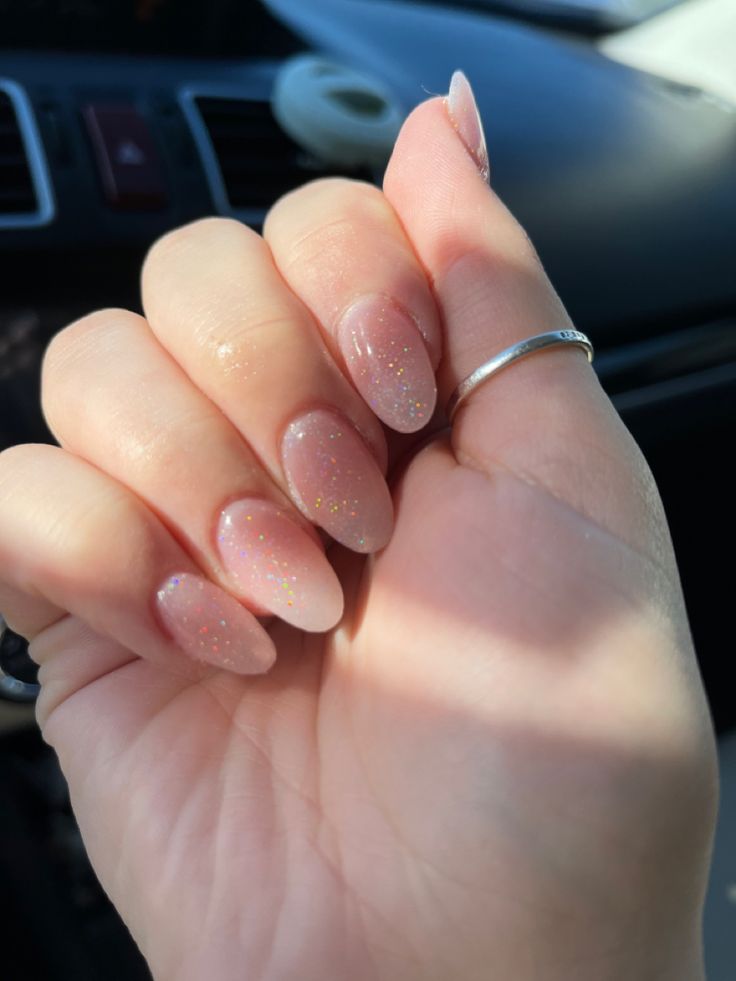 Elegant Soft Pink Oval Nails with Subtle Sparkle for Any Occasion.