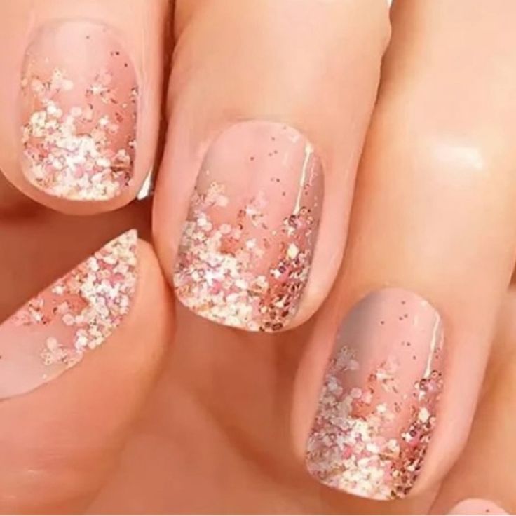 Elegant Ombre Nail Design: Soft Nude to Sparkling Rose Gold Glitter Transition.