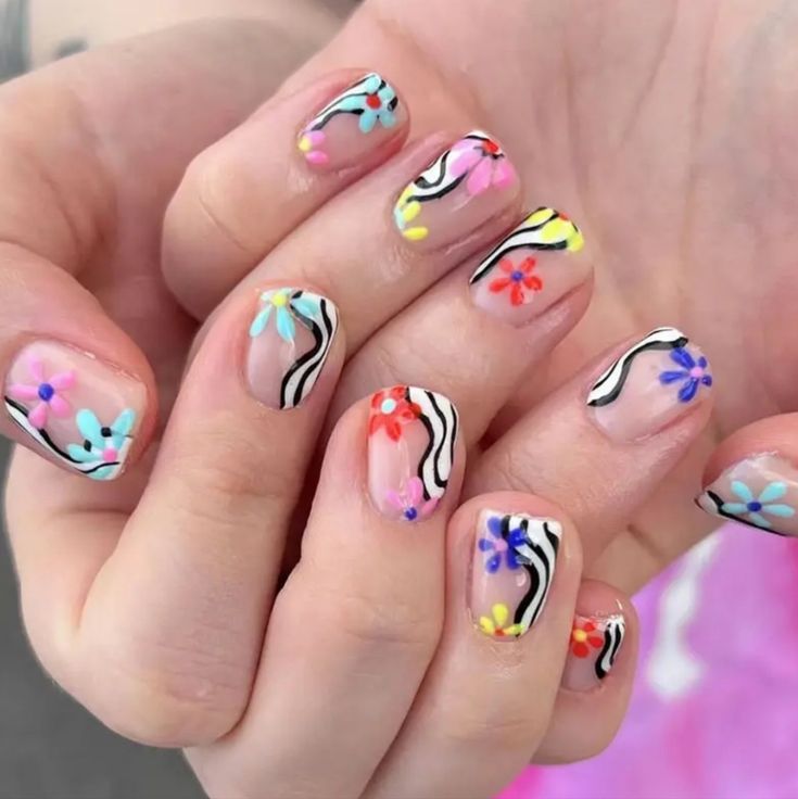 Colorful Floral Nail Art with Bold Stripes and Intricate Details.