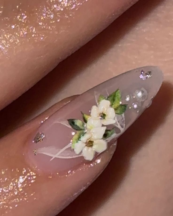 Elegant Floral Nail Art with White Blossoms and Gemstone Accents on Translucent Base