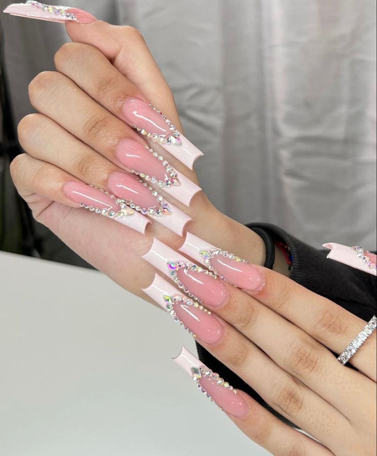 Glamorous Soft Pink Acrylic Nail Design with Rhinestone Embellishments for Special Occasions.