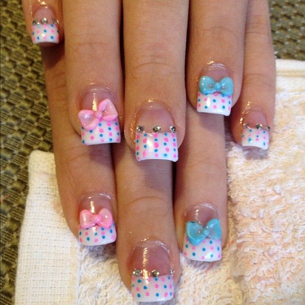 Cheerful Pastel Polka Dot Nail Design with Bows and Rhinestones for a Playful Touch.