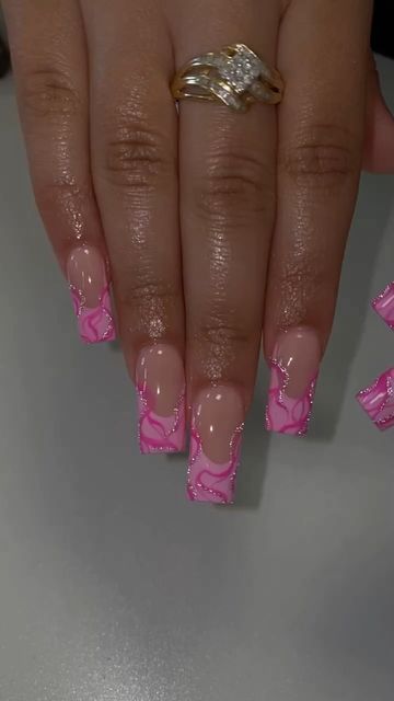 Trendy Vibrant Pink Nail Design with Glossy Swirls and Chic Gold Accents