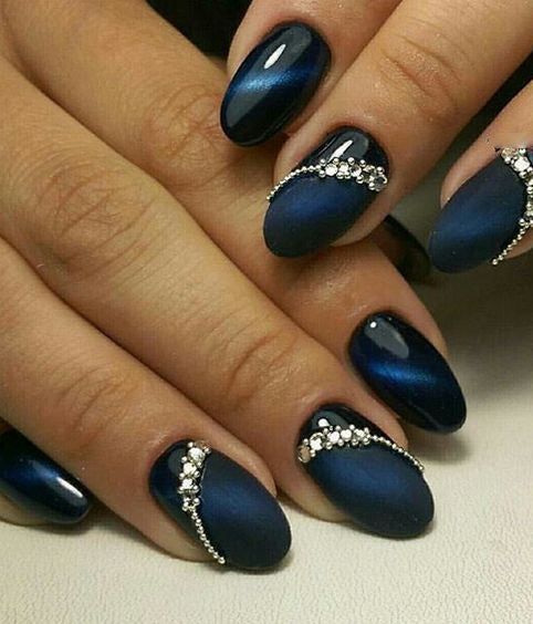 Sophisticated Navy Blue Oval Nails with Glossy and Matte Finishes, Adorned in Wavy Silver Embellishments.