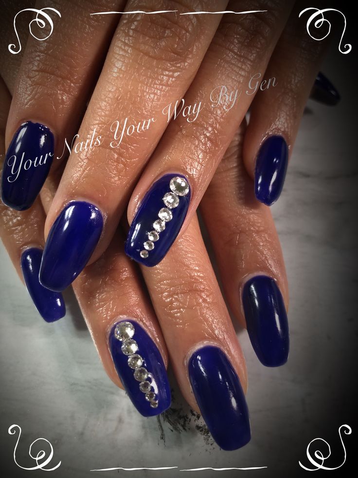 Striking Sophistication: Deep Blue Long Nails with Glamorous Rhinestone Accents.