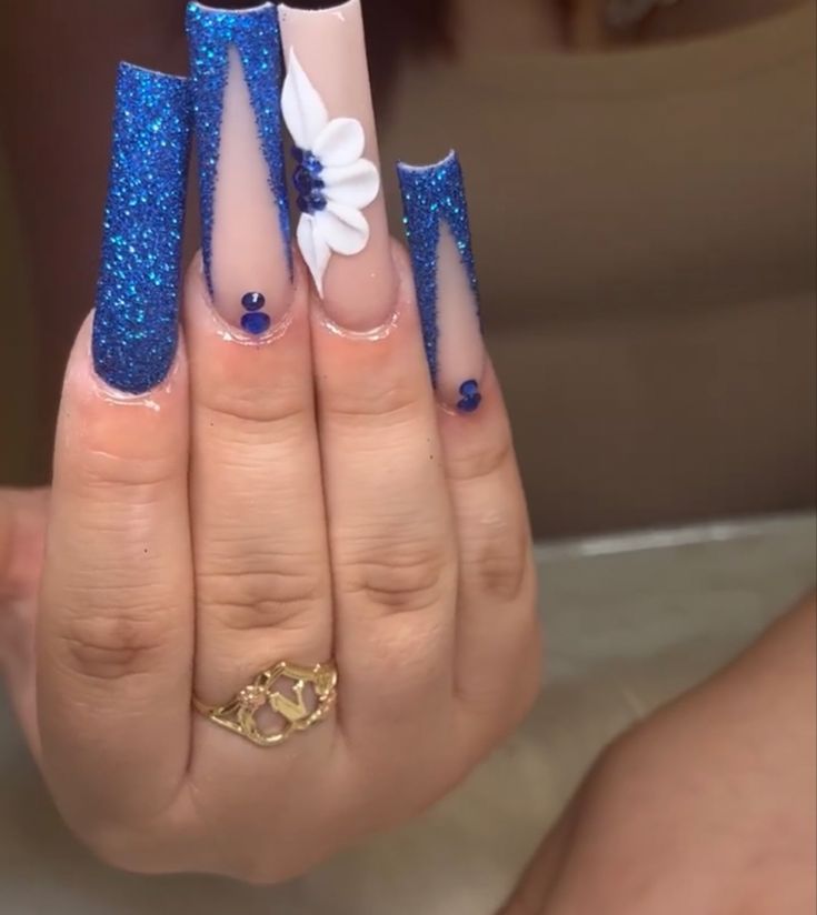 Glamorous Sparkling Blue Stiletto Nails with Accents and Floral Detailing