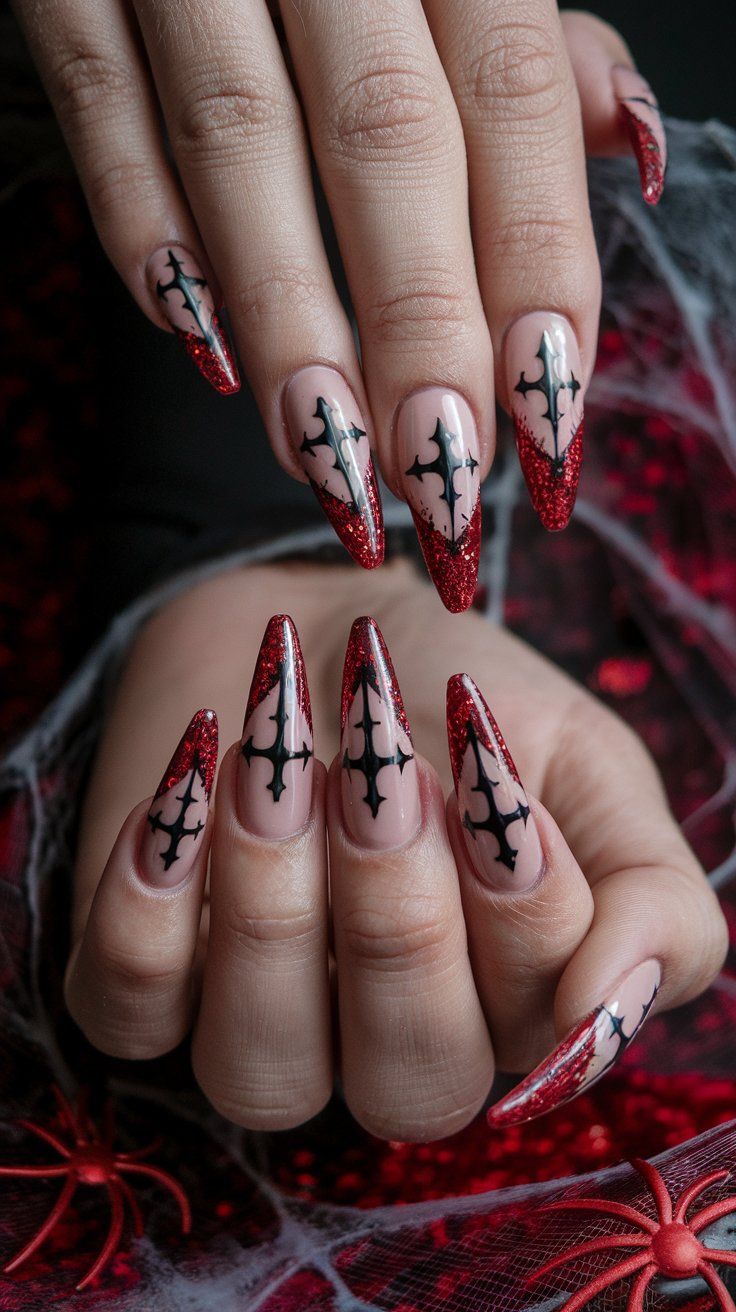 Elegant Glamorous Nail Design: Striking Red and Nude with Intricate Black Patterns in Stiletto Shape.