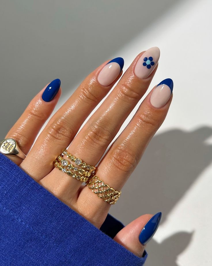 Chic Elegant Nail Design: Deep Blue and Nude Tones with Playful Accent and Gold Accents