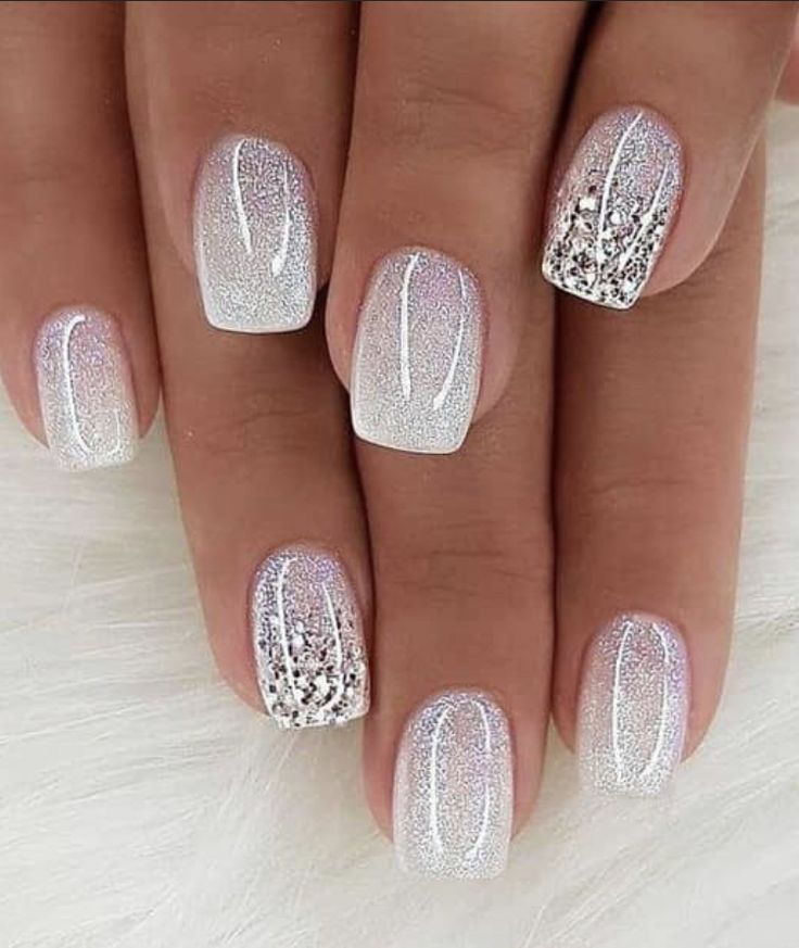 Elegant Glittery Ombre Nails with Silver Hues and Delicate Accents.