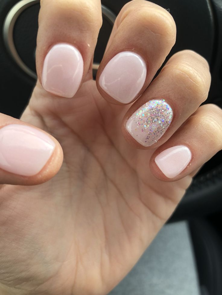 Elegant Soft Pink Nails with Glitter Accent for a Subtle Glamour.