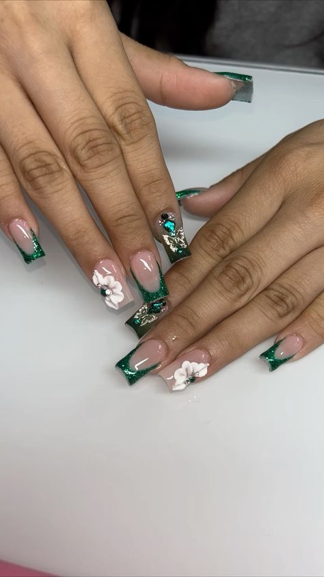 Sophisticated Glossy Nude Nail Design with Vibrant Green Tips and Floral Accents.