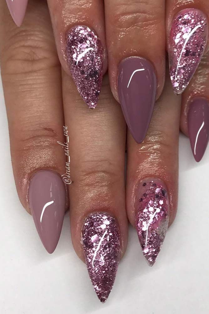 Glamorous Stiletto Nail Design: Soft Mauve Meets Sparkling Glitter with Holographic Accents.