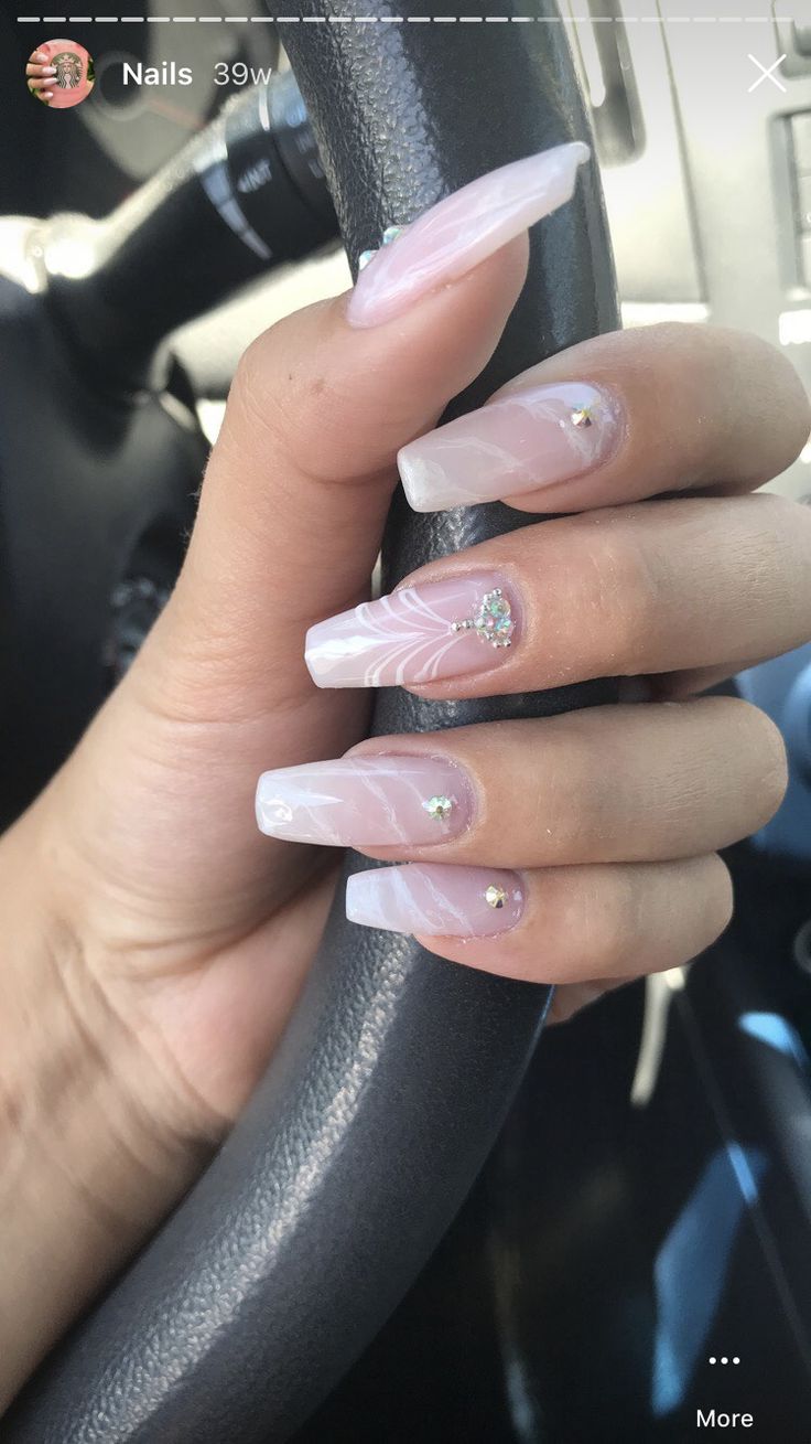 Sophisticated Long Nails with Marble Overlay and Sparkling Rhinestone Accents.