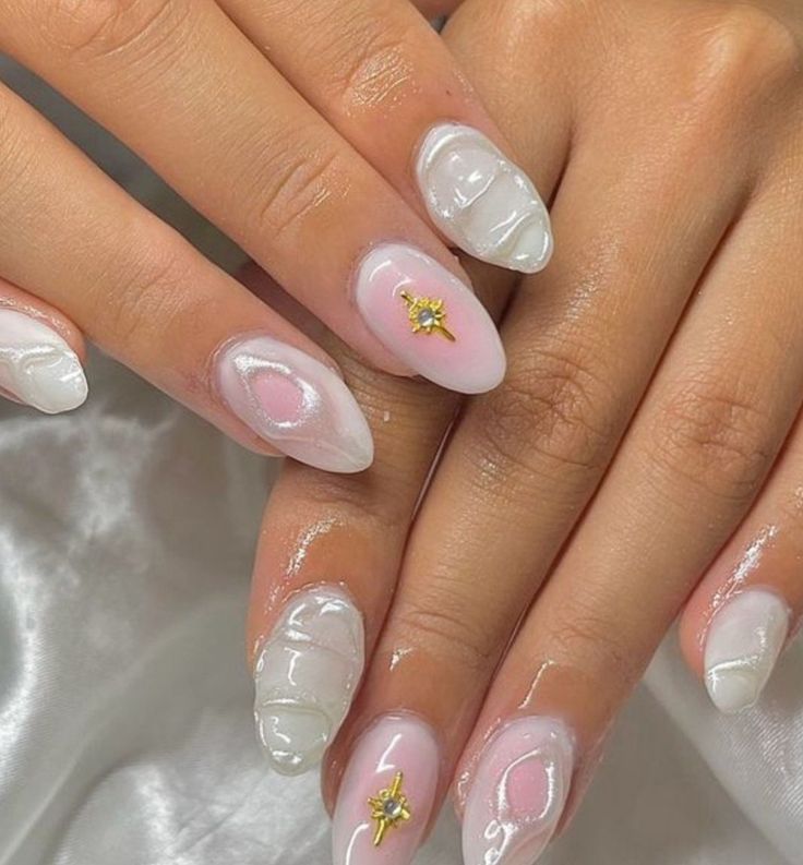 Sophisticated Nail Design: Glossy Translucent White and Pale Pink Swirls with Delicate Gold Accents