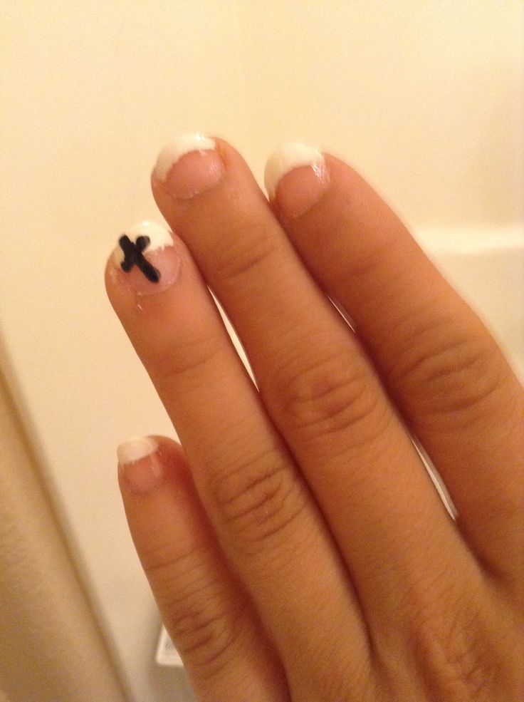 Chic French Manicure with Unique Black Cross Accent.