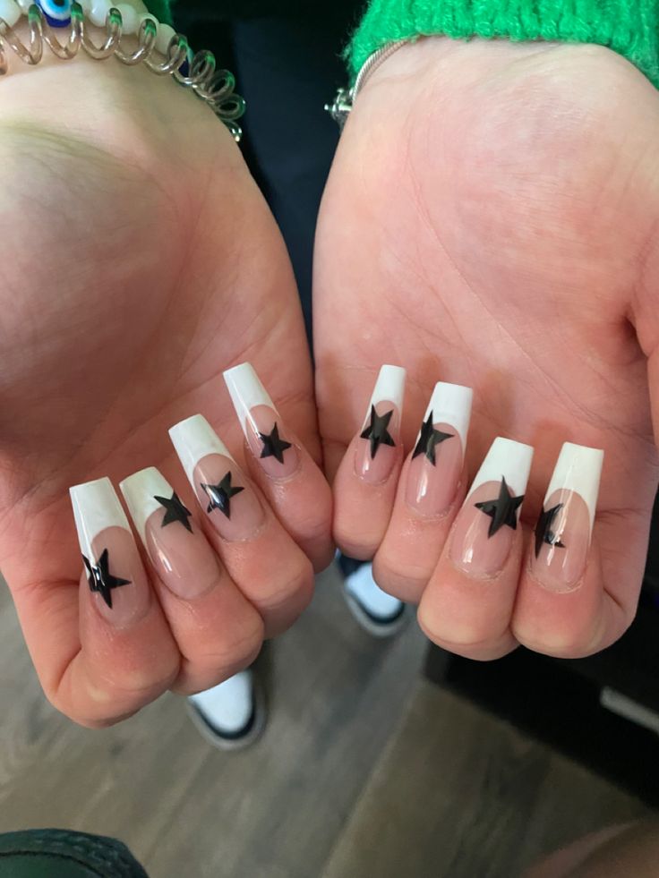 Chic Long French Tip Nails with Bold Black Star Motifs