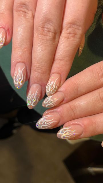 Glamorous Flame-Inspired Nail Design with Soft Nude Base and Holographic Accents