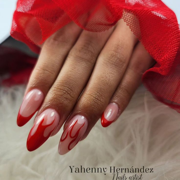 Bold Elegant Nail Design with Soft Nude and Artistic Red Flame Patterns.