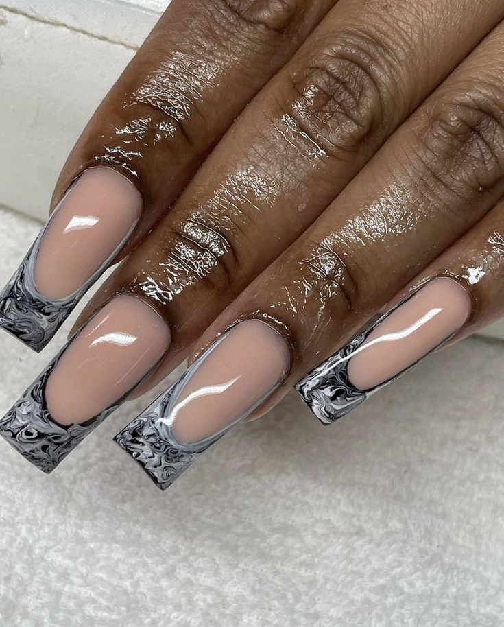 Chic Marbled Nail Design: Nude Base with Bold Black and White Tips