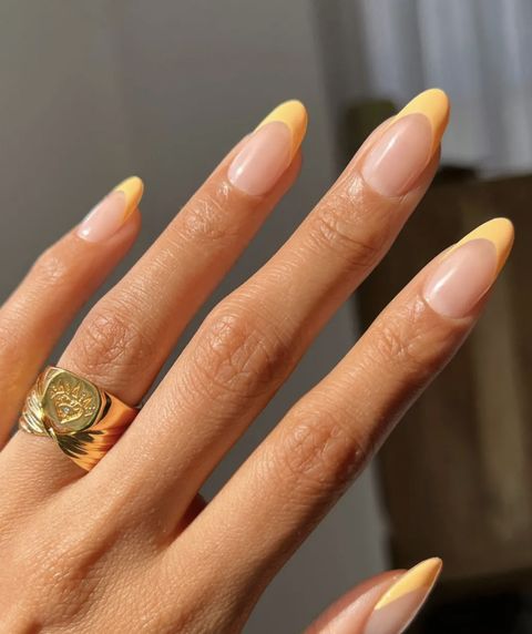 Chic Yellow French Tip Almond Nails with Sophisticated Gold Accent.