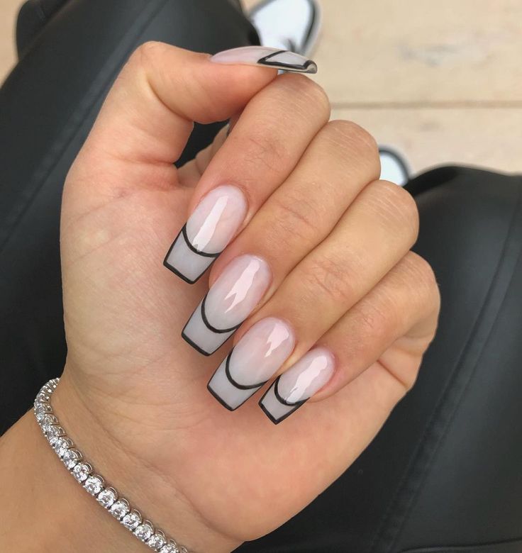 Chic Modern Nail Design: Clear Base with Soft Pink and Bold Black Accents.