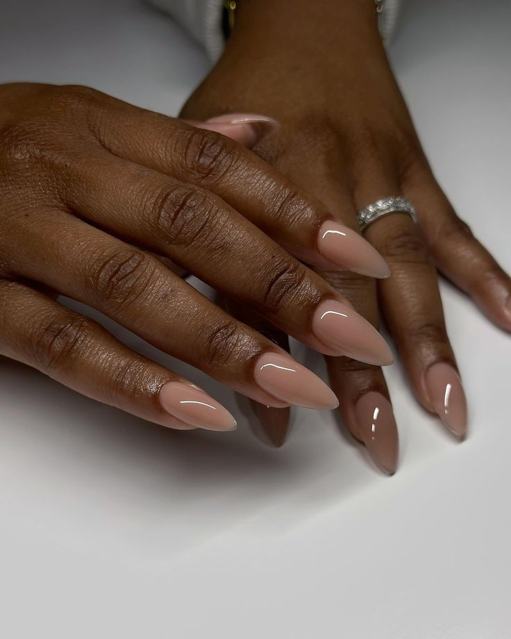 Sophisticated Almond-Shaped Nails with Glossy Nude Polish for Timeless Elegance.