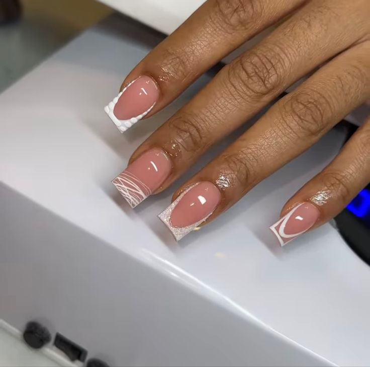 Sophisticated Nail Design: Nude Base with Chic White Tips and Geometric Patterns