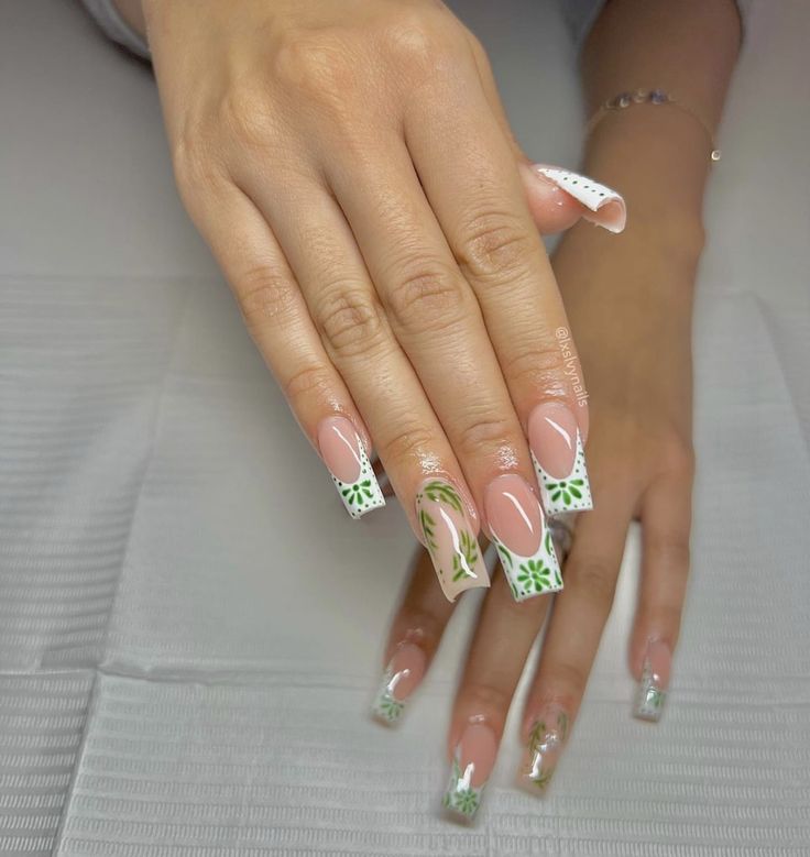 Elegant Nude Nail Design with Vibrant Green Floral Accents.