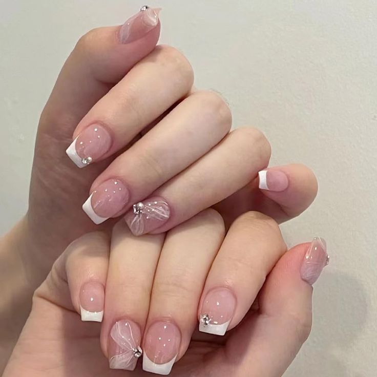 Chic Elegant Nail Design with Soft Pink Hues and Feminine Embellishments.