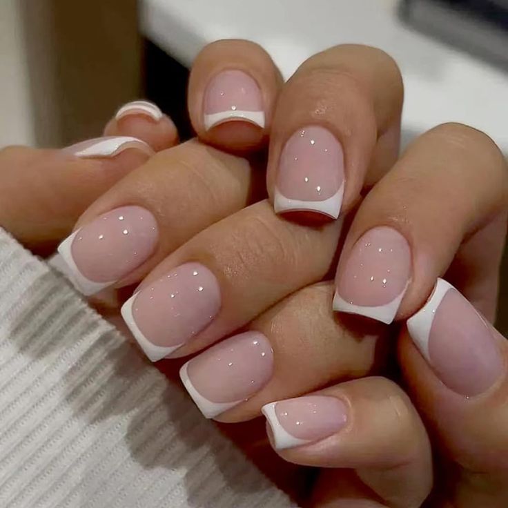 Sophisticated Elegant French Manicure with Soft Pink Base and Glittering White Tips.