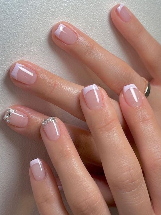 Chic French Manicure with Glitter Accents: A Sophisticated Yet Fun Nail Design