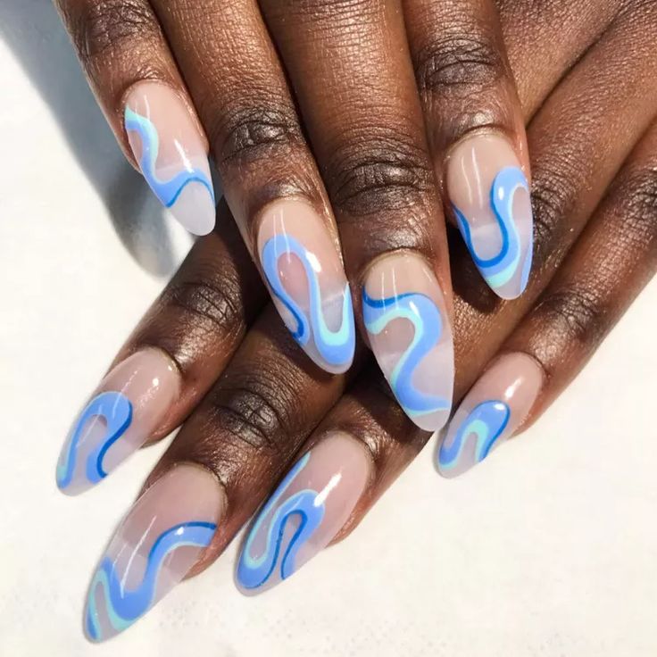 Chic Long Nails: Elegant Blend of Soft Nude and Soothing Blue with Artistic Wavy Patterns.