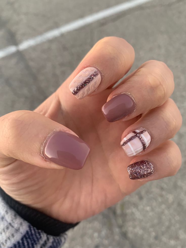 Sophisticated Nail Art: Muted Mauve with Glitter and Playful Stripes.