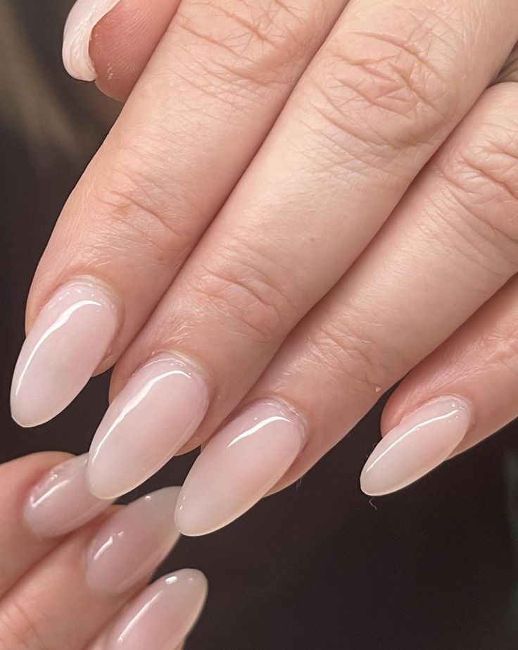 Timeless Almond-Shaped Nails with Translucent Nude Polish for Effortless Sophistication.